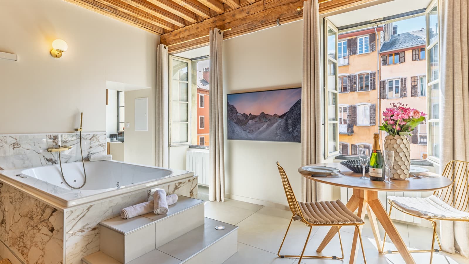 Balnéo, coin repas et vue sur les sommets depuis la suite Pure Haven